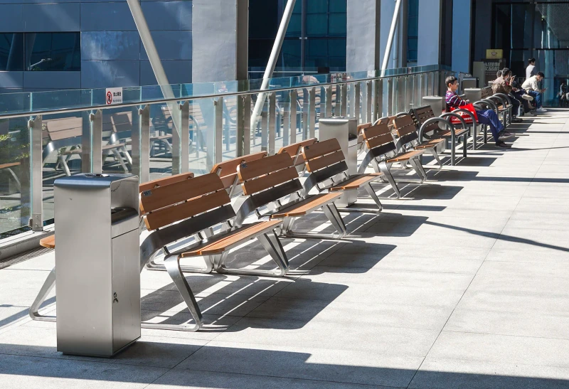 Outdoor litter bins beside rows of benches at the Canton Fair Complex.